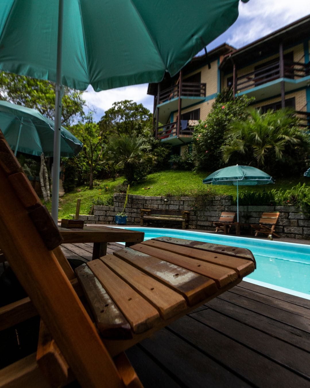 Piscina e área externa cercada pela natureza no Paraíso Hostel Praia do Rosa